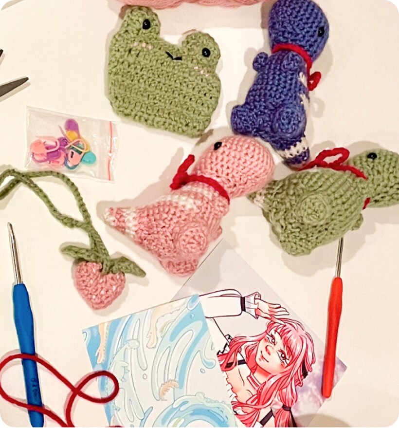 Crocheted frog and yarn projects in progress