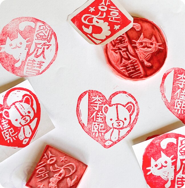 Hand-carved red name stamps in heart and round shapes
