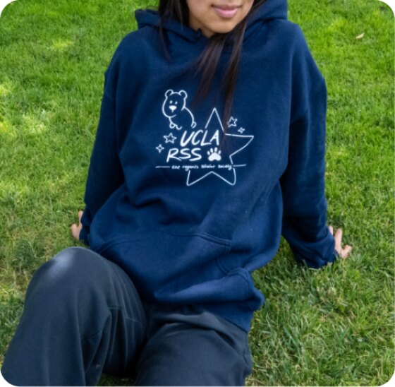 Navy hoodie photographed on a model, front design showing the bear and UCLA RSS star