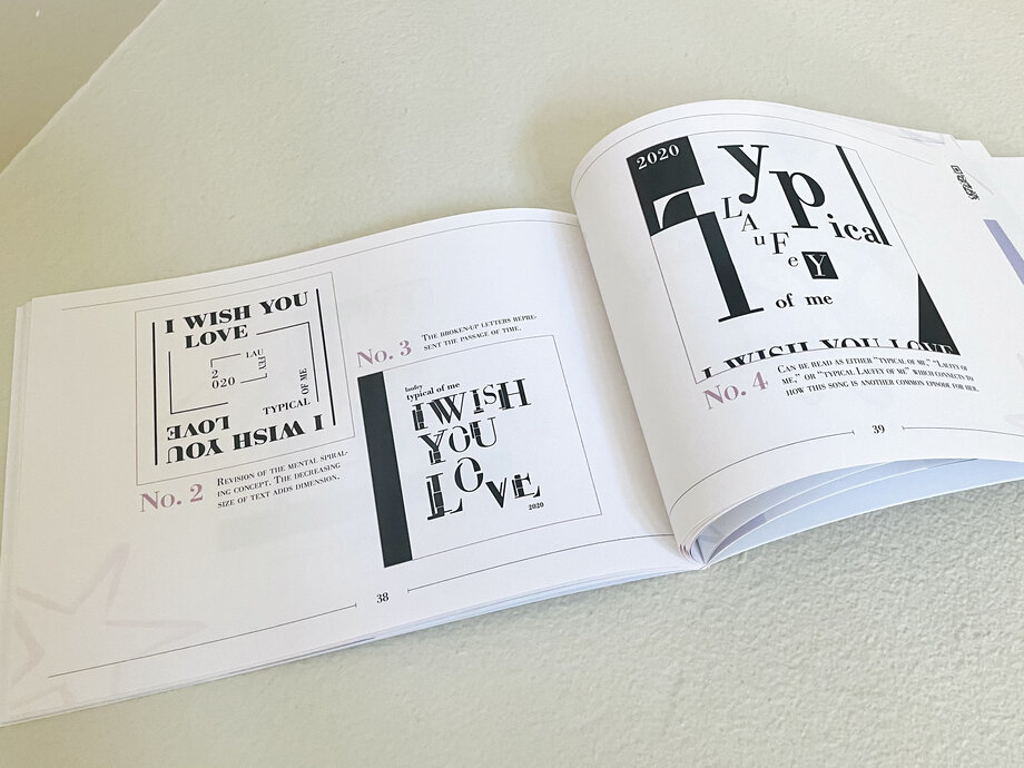 Open songbook showing layered type compositions