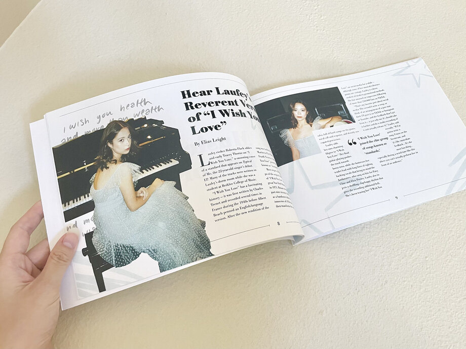Open songbook held up showing a photo spread