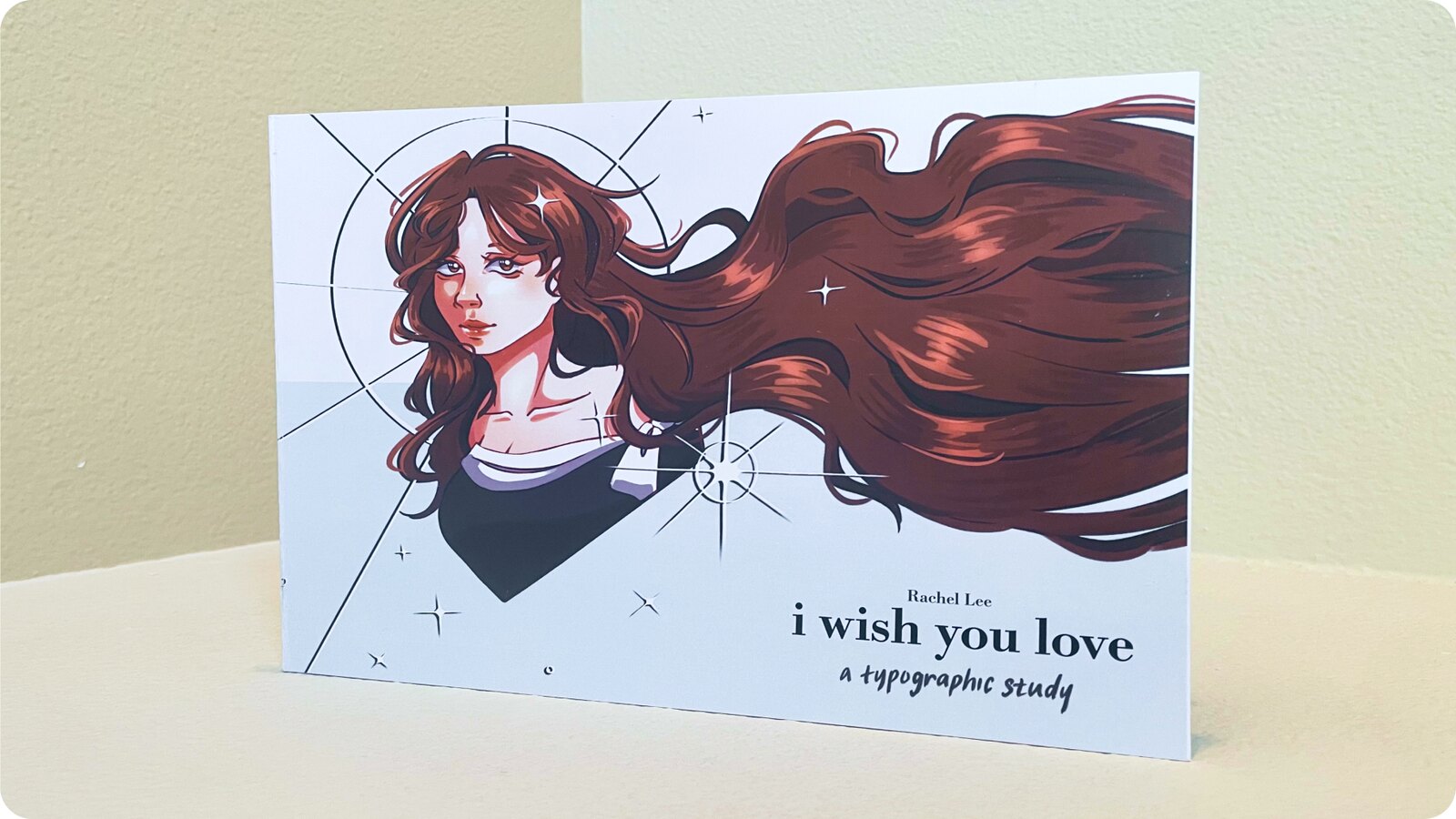 Photo of the physical &ldquo;I Wish You Love&rdquo; songbook standing upright, showing its printed cover